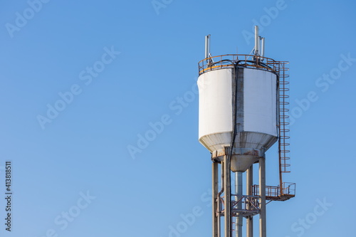 Canvastavla Water supply tower set against blue sky and white snow