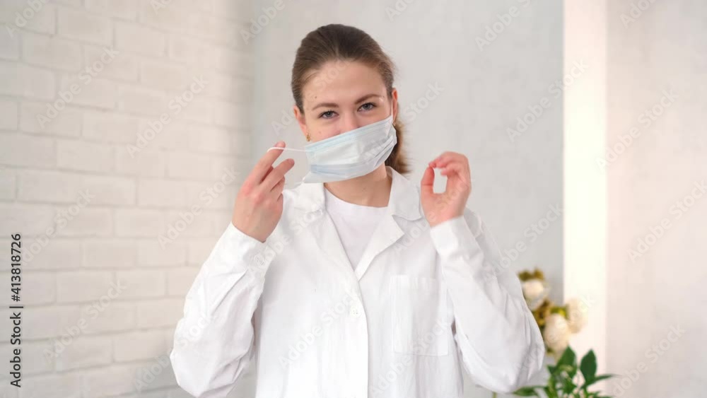 close-up portrait of a Caucasian female medical worker in a hospital, wearing a surgical gown and wearing a surgical mask. Doctor in the Ncov 19 Coronavirus Pandemic close-up portrait of a Caucasian female medical worker in a hospital, wearing a surgical gown and wearing a surgical mask. Doctor in the Ncov 19 Coronavirus Pandemic