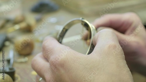Close ups of a craftsman making jewellery in a workshop. photo