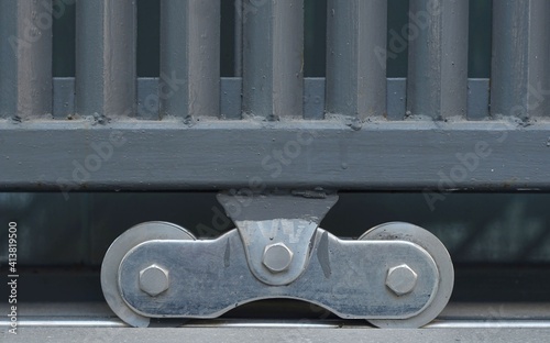 Close-Up a Steel door wheel of a steel door fence.