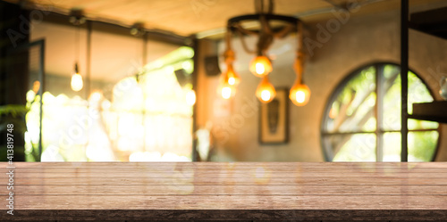 Empty wooden top table on blur restaurant background.