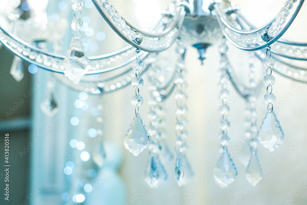 Chrystal chandelier close-up. blue light. Selective focus Chrystal chandelier close-up. blue light. Selective focus