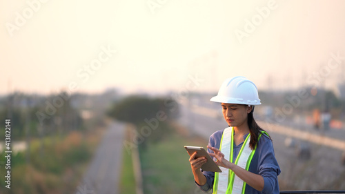 Female civil Engineering working with tablet on bridge highway