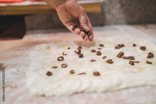 Making focaccia with olives