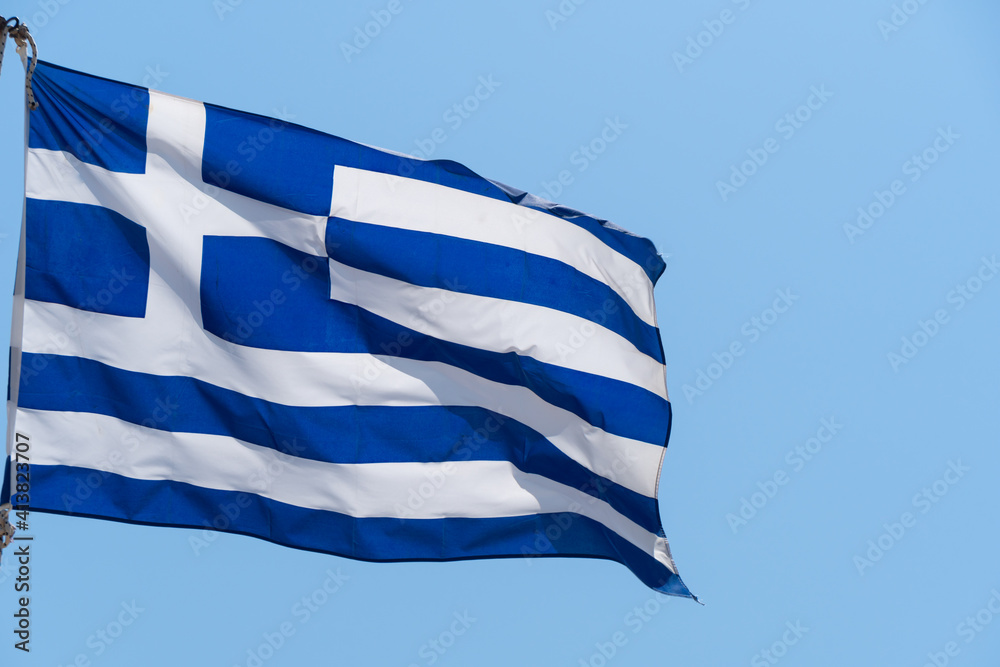 Obraz premium Greek flag waving on the blue sky background. National symbol of Greece, waving flag.