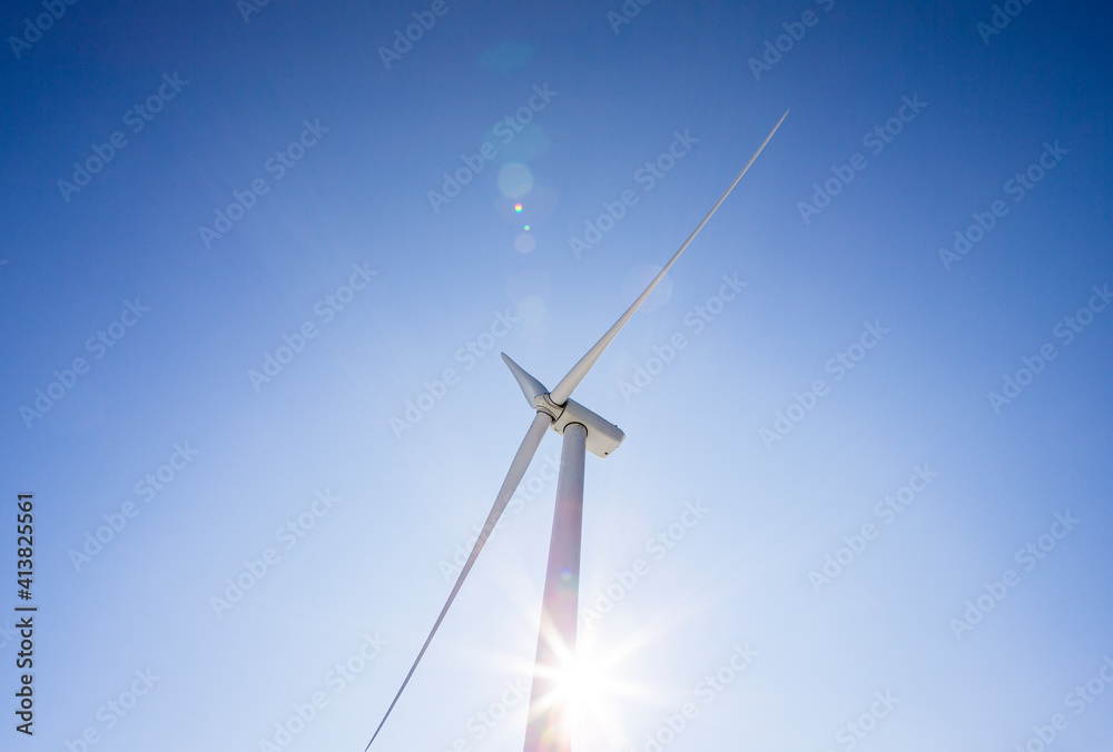 Wind turbine low angle against blue sky Wind turbine low angle against blue sky