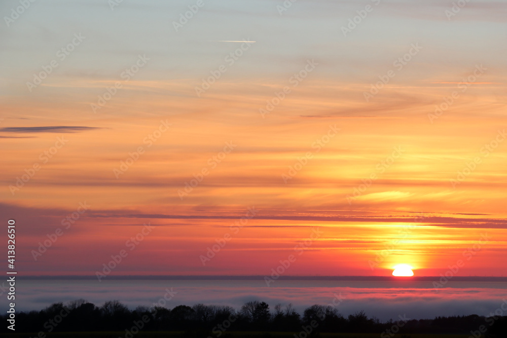 Atmospheric sunset over thin clouds
