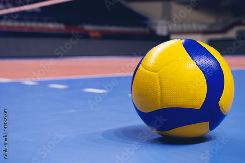 Volleyball ball on blurred wooden parquet background. Banner, space for text, close up view with details.