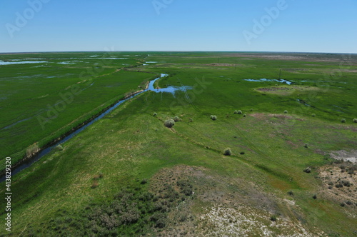 Zhambyl region, Kazakhstan - 05.17.2013 : An open valley with a riverbed and different vegetation for grazing animals photo