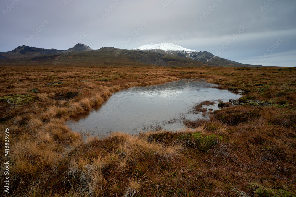 Small pond in valley with dry grass Small pond in valley with dry grass
