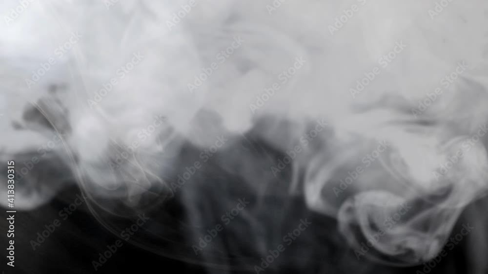 White smoke on black background in slow motion
