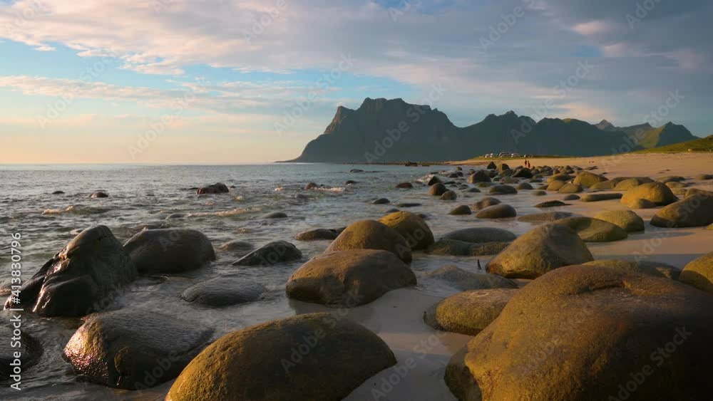 Sunset over the rocky shoreline of Uttakleiv Beach in the Lofoten Island, Norway Sunset over the rocky shoreline of Uttakleiv Beach in the Lofoten Island, Norway