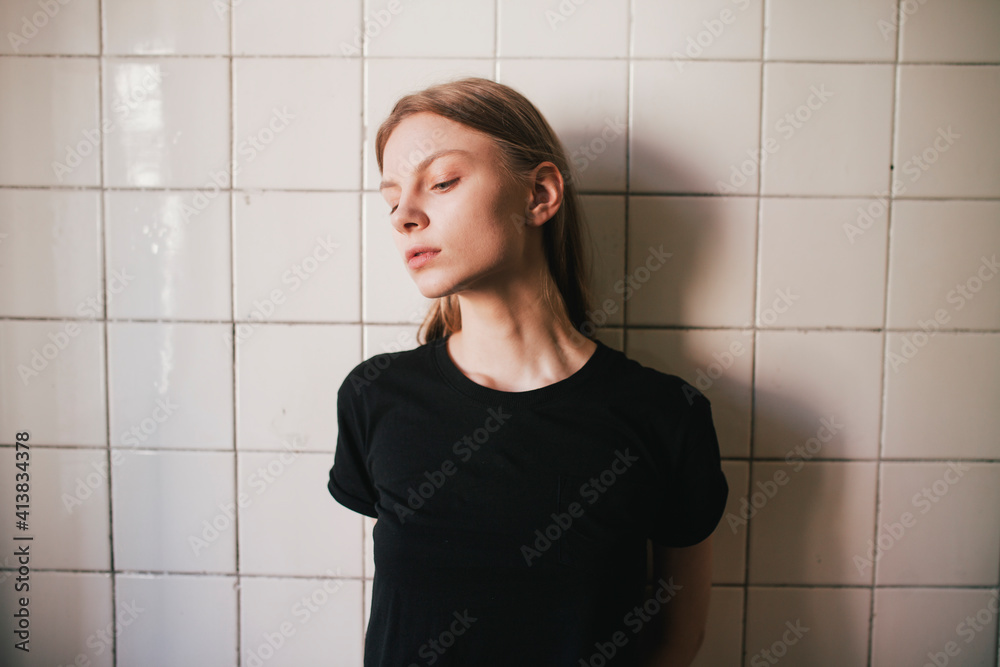 Portrait of a woman against a tiled wall Portrait of a woman against a tiled wall