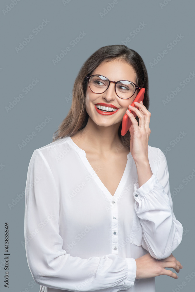 Business woman with glasses talking on smartphone
