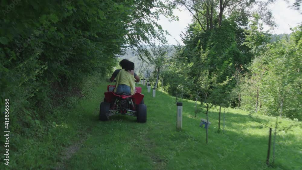 Young couple enjoy driving quad bike in forest Young couple enjoy driving quad bike in forest