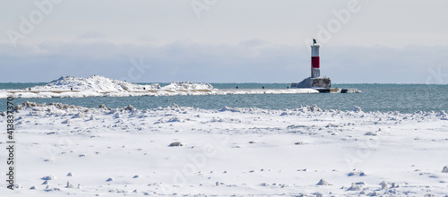 snow covered winter lake shore lighthouse