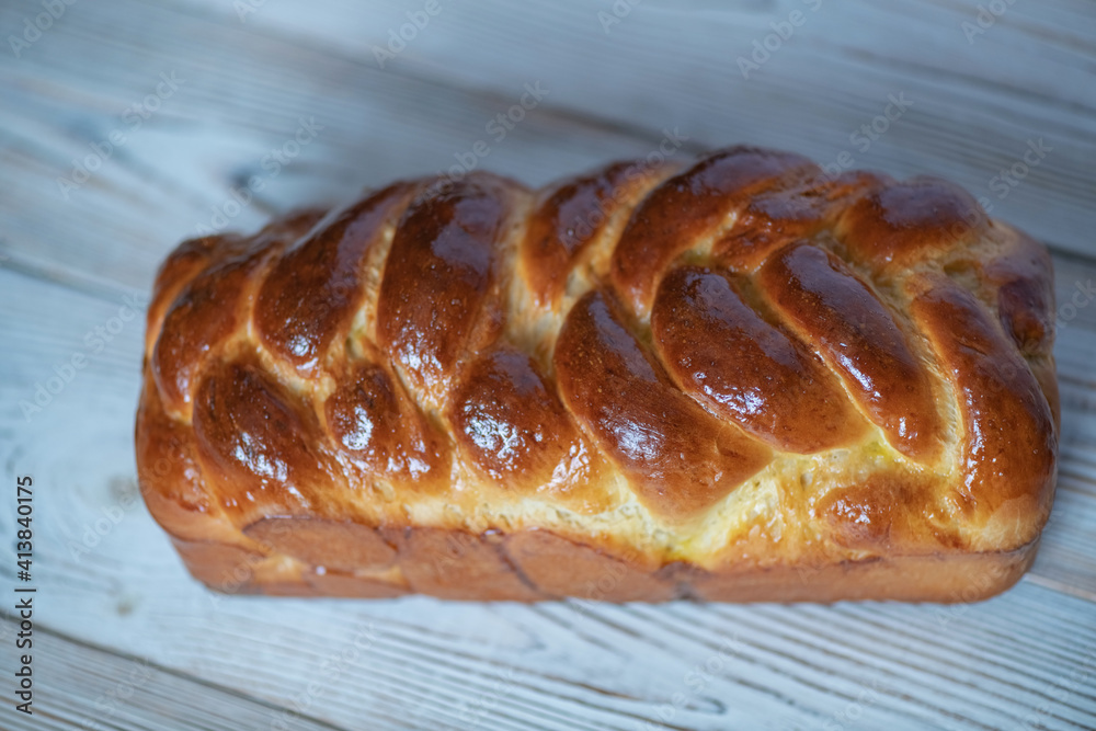 Loaf of homemade wicker white bread on a wooden background, close-up. Loaf of homemade wicker white bread on a wooden background, close-up.