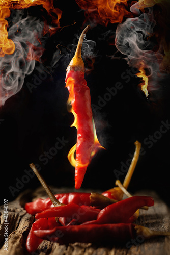 Red hot chili peppers burns. A blackout background on fire.