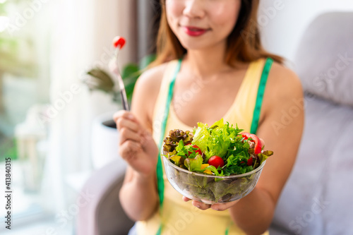 Young woman eating homemade healthy salad at home, Healthy eating lifestyle and diet concept