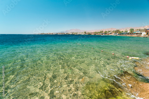 Red Sea Dahab blue water with mountainy in the background photo