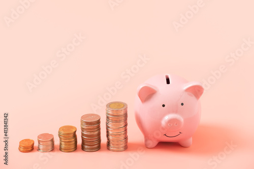 Pink piggy bank and stacking coin for saving concept on pink background, Financial planning for a future concept, copy space