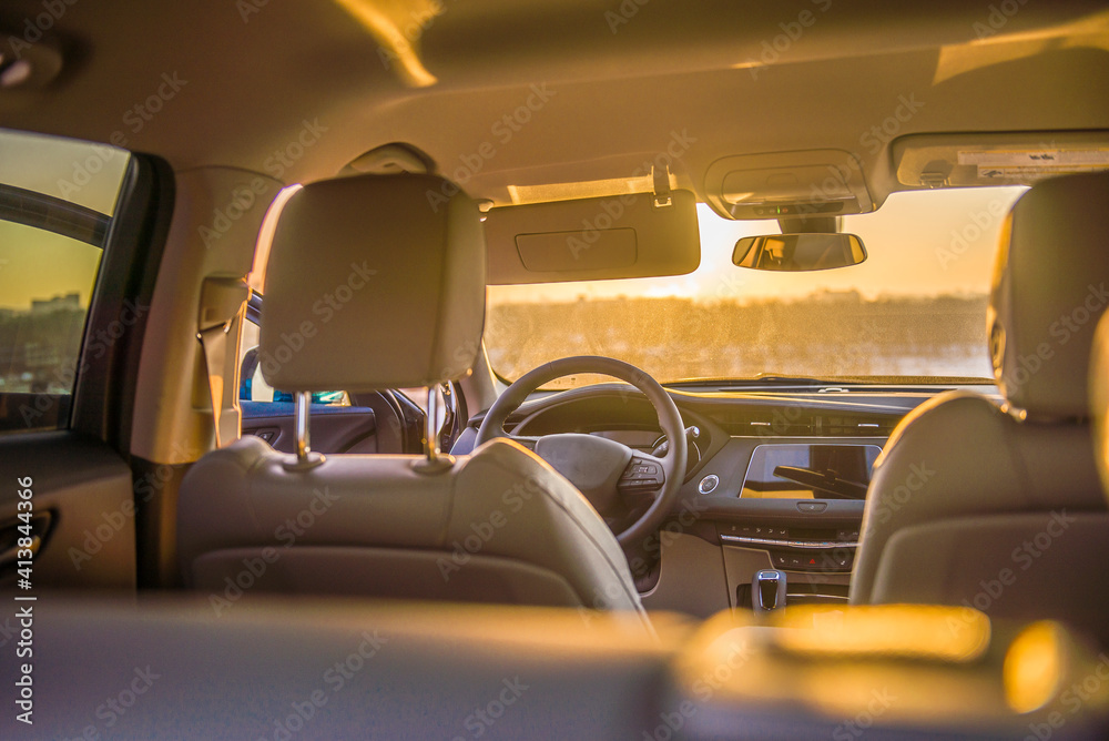 View of city skyline from inside luxury car at sunset View of city skyline from inside luxury car at sunset