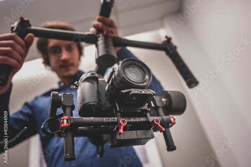 Videographer filming with gimbal and dslr photo
