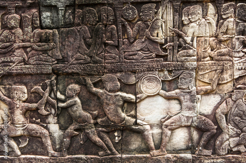 Carvings of a battle scene on a wall at Angkor Wat, Cambodia. photo