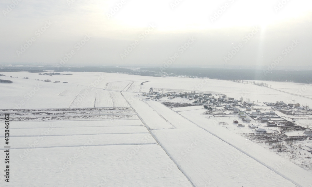 Top view of rural landscape with snow covered field in winter Top view of rural landscape with snow covered field in winter