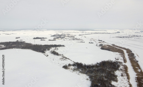 Top view of rural landscape with snow covered field in winter © Payllik
