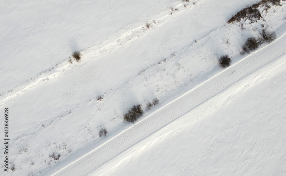 Top view of rural snowy road in winter