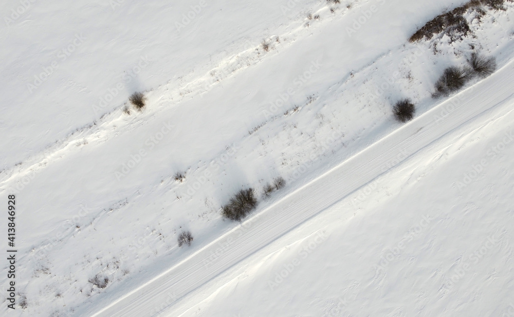 Top view of rural snowy road in winter Top view of rural snowy road in winter