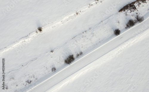 Top view of rural snowy road in winter