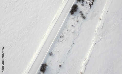 Top view of rural snowy road in winter © Payllik