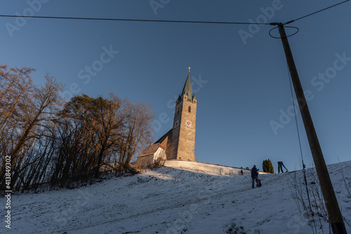 Kirch mit Friedhof im Winter vor blauem, Himmel, Tüßling,  St. Rupertus photo