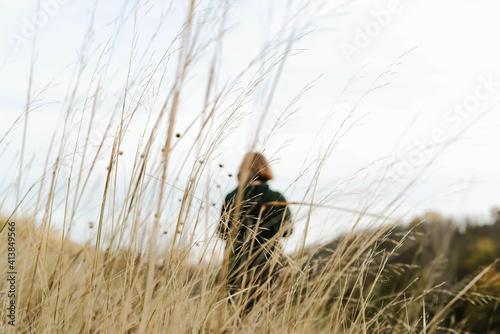 Back view  of a  woman on a sunny day in autumn