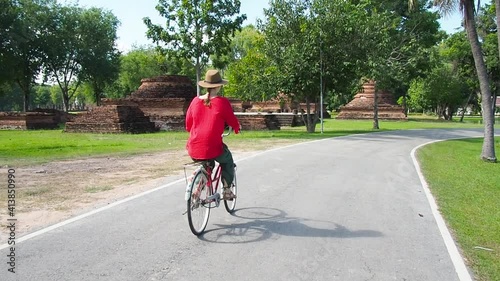 Wallpaper Mural Woman ride bicycle near temple in Thailand Torontodigital.ca