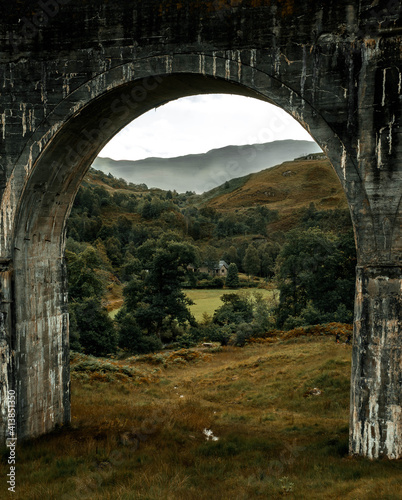 Arched bridge and view of the mountains and forest house photo