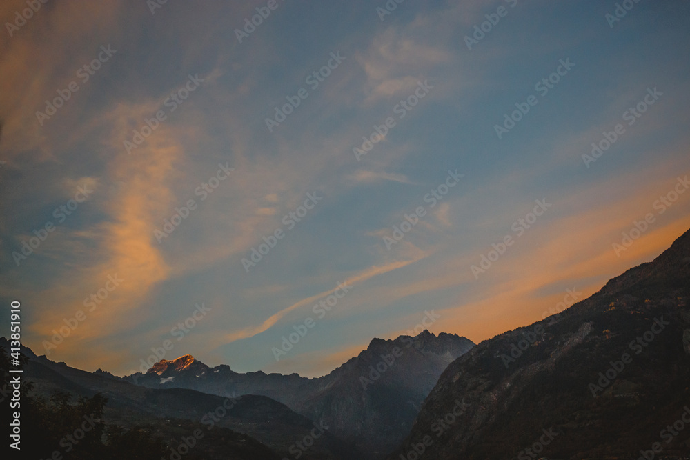 the very top of a mountain peak illuminated by the last of the sunset the very top of a mountain peak illuminated by the last of the sunset