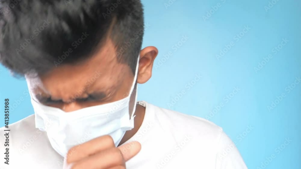 young man with surgical mask coughing and sneezes close up young man with surgical mask coughing and sneezes close up