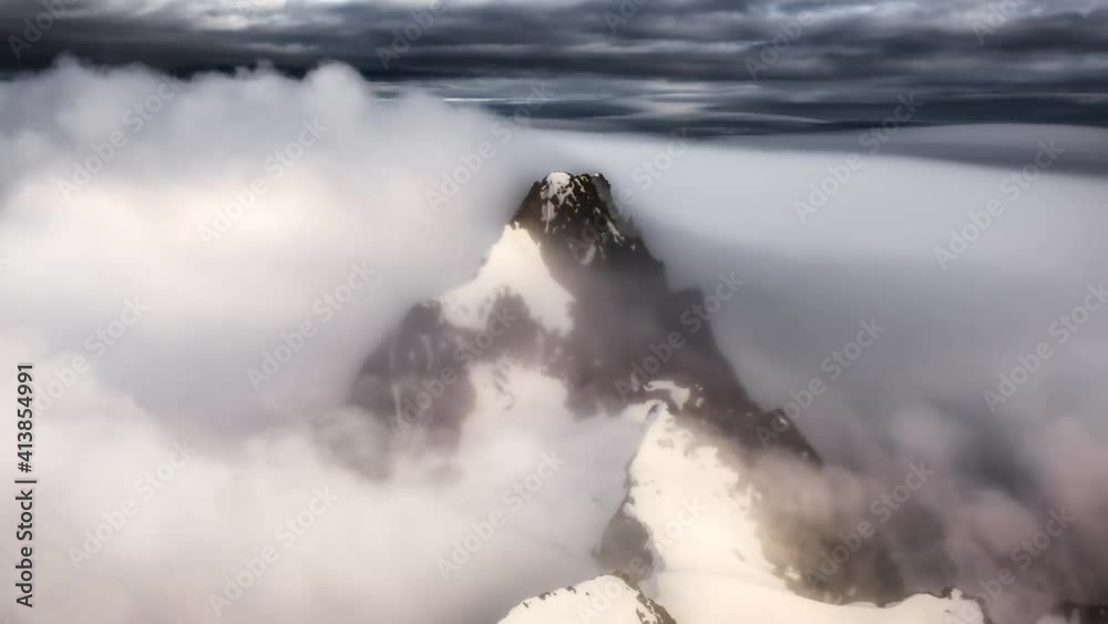 Aerial landscape view of the snow covered mountain range near Squamish and Vancouver, British Columbia, Canada. Artistic Dramatic Colorful Sunset Render. Parallax Animation Aerial landscape view of the snow covered mountain range near Squamish and Vancouver, British Columbia, Canada. Artistic Dramatic Colorful Sunset Render. Parallax Animation