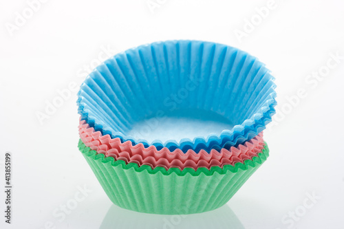 Stack of colorful cupcake cases.