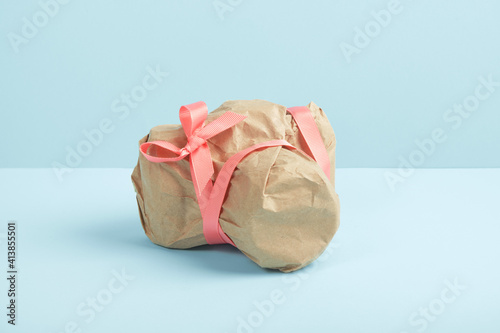 Photo camera wrapped in craft paper. Mysterious surprise, gift
