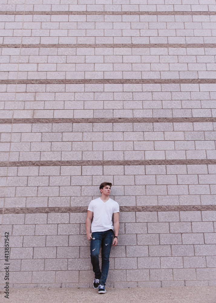 Handsom Man standing against brick wall Handsom Man standing against brick wall