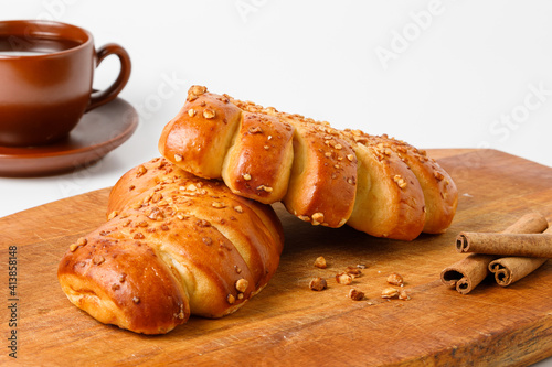 Two croissants on a wooden board