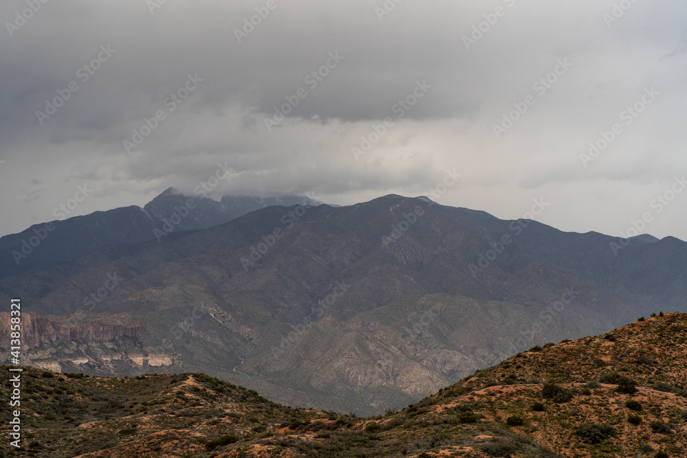 Low hangin clouds shroud distant mountain peaks on this hiking trail Low hangin clouds shroud distant mountain peaks on this hiking trail