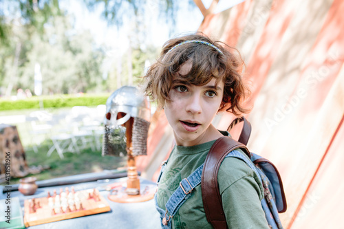 Teen girl filled with wonder after looking at head armor photo