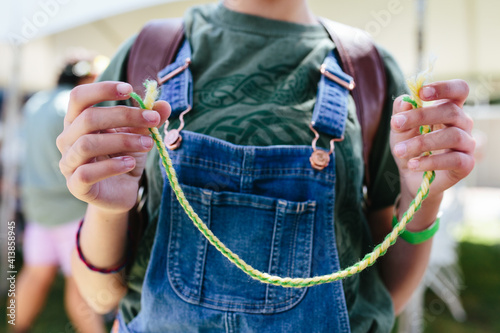 Closeup of young teen girl's hands holding yarn whipcord