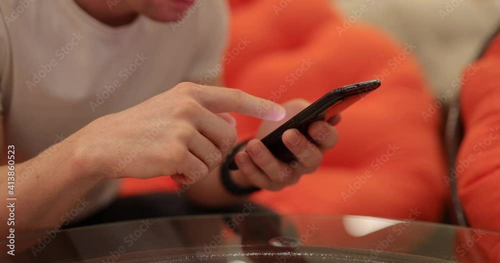 Male hands flipping through the black phone Male hands flipping through the black phone