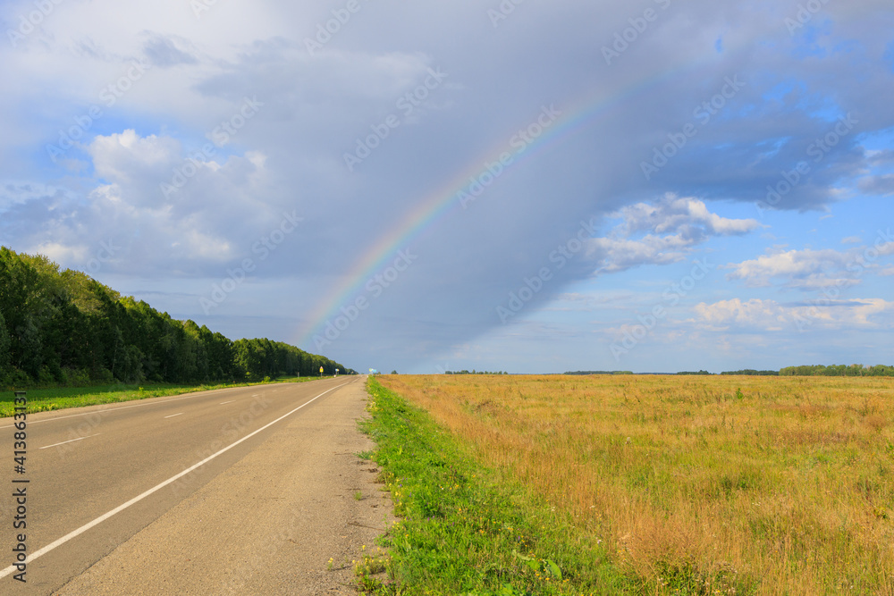 view from the side of the road and the rainbow above it